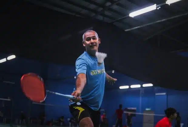 man in blue crew neck t-shirt and black shorts holding red basketball